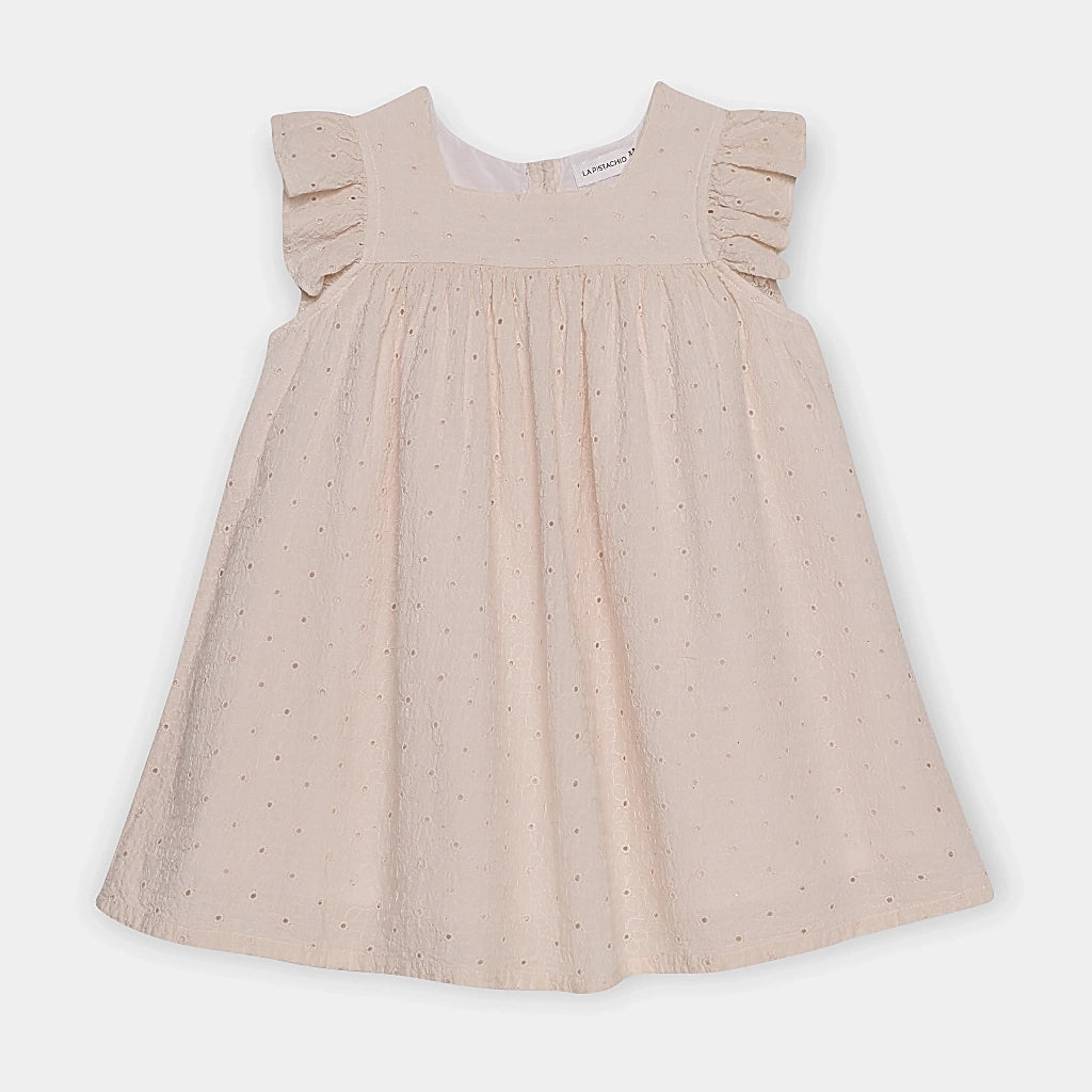 Beige dress with ruffled shoulders on a white background