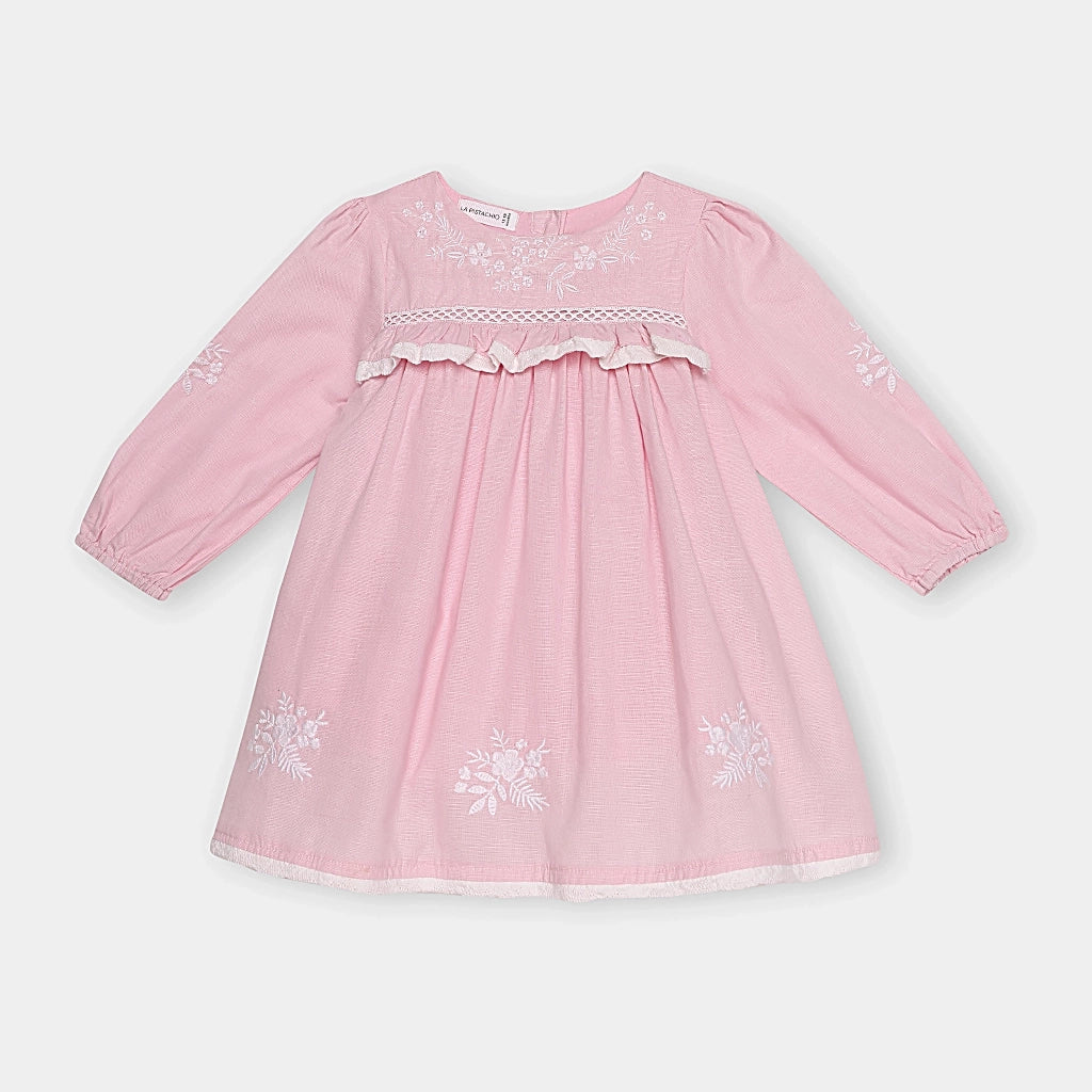 Pink dress with floral embroidery on a white background