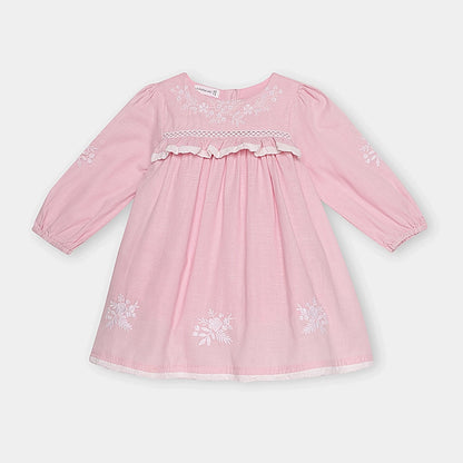Pink dress with floral embroidery on a white background