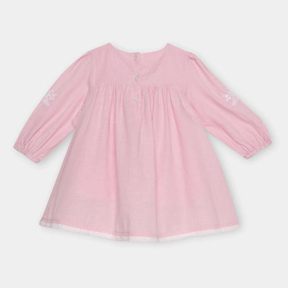 Pink dress with long sleeves on a light gray background