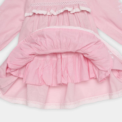 Close-up of a pink dress with ruffled layers on a white background