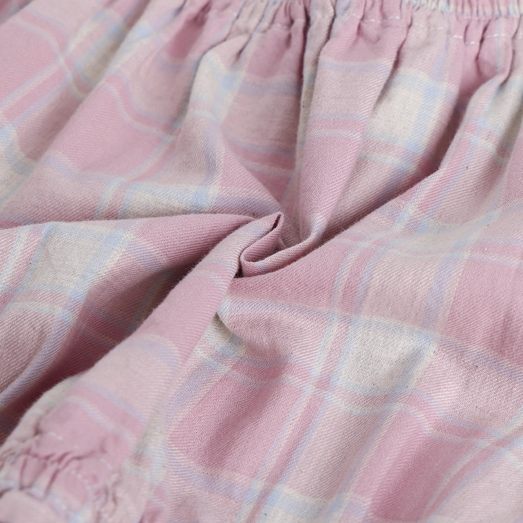 Close-up of pink plaid fabric with a soft texture