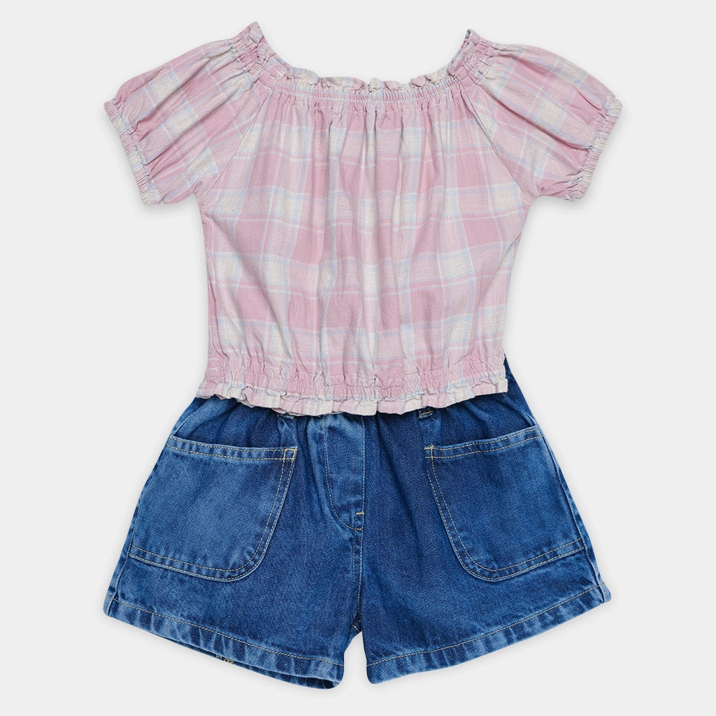 Pink plaid top and blue denim shorts on a white background
