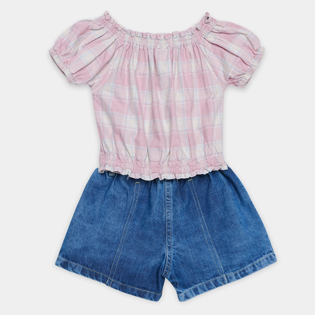 Pink plaid top and blue denim shorts set on a white background