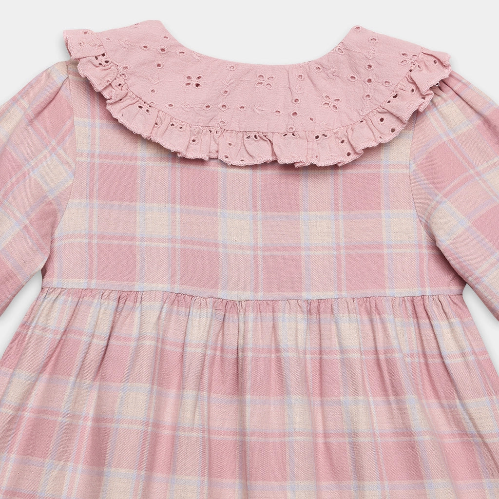 Pink plaid dress with ruffled collar on a white background
