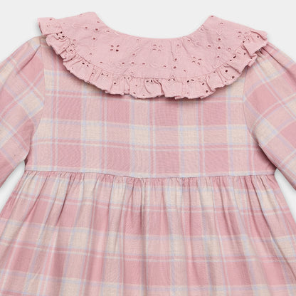 Pink plaid dress with ruffled collar on a white background