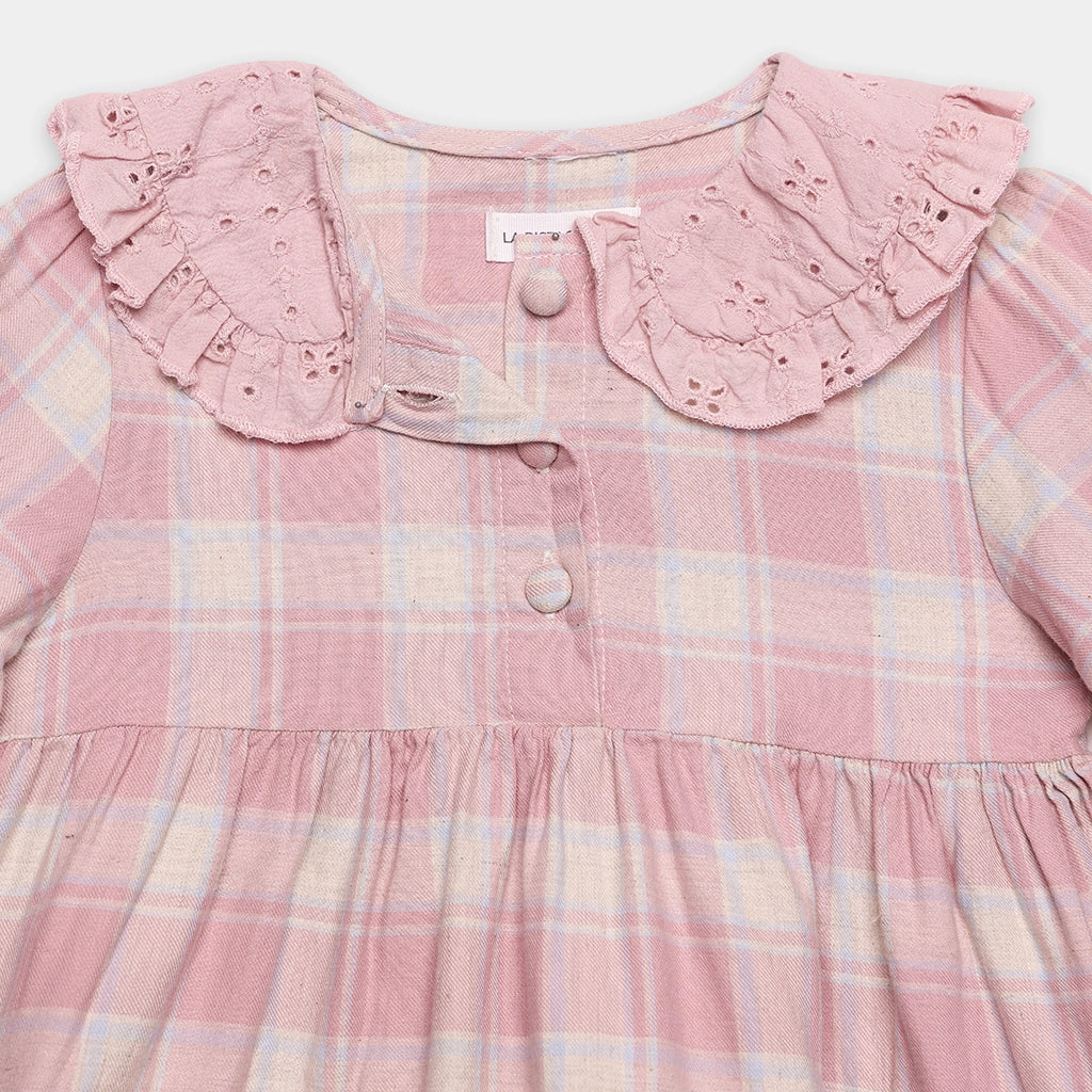 Pink plaid dress with lace collar on a white background