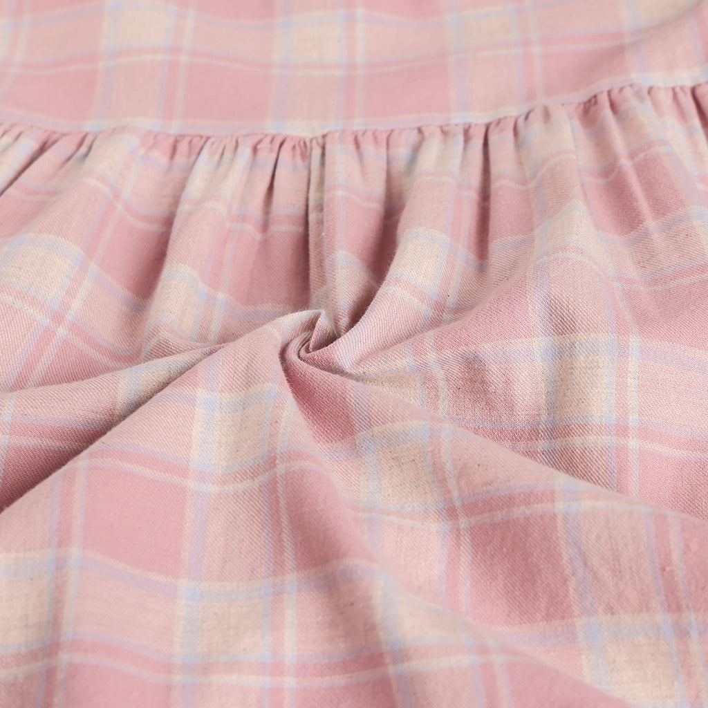 Close-up of pink plaid fabric with a soft texture