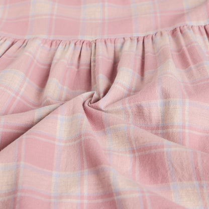 Close-up of pink plaid fabric with a soft texture