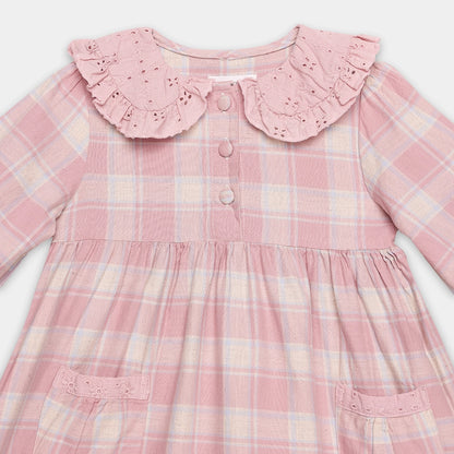 Pink plaid dress with ruffled collar on a white background