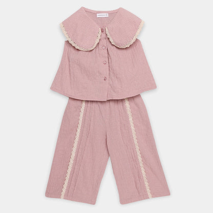 Pink checkered outfit with lace details on a white background