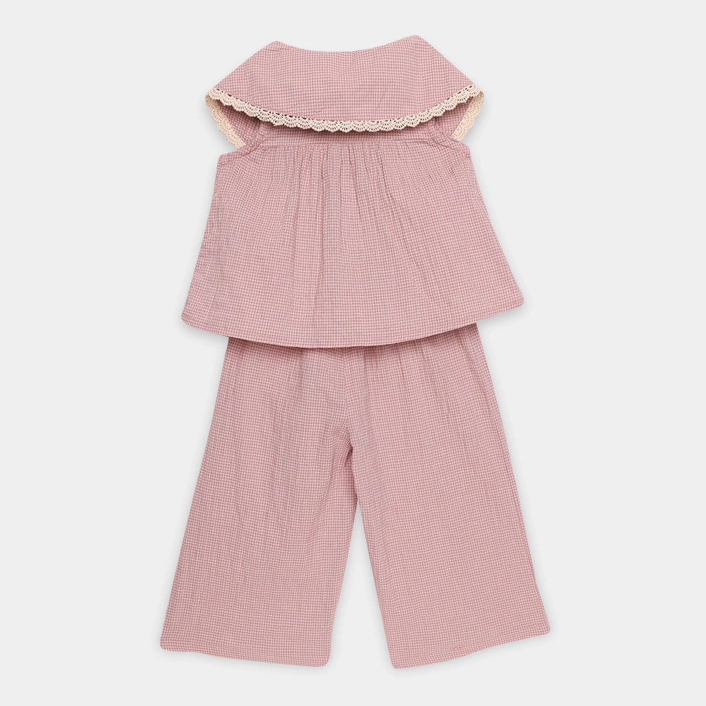 Pink checkered outfit with a top and pants on a white background