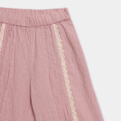 Pink checkered pants with lace trim on a white background