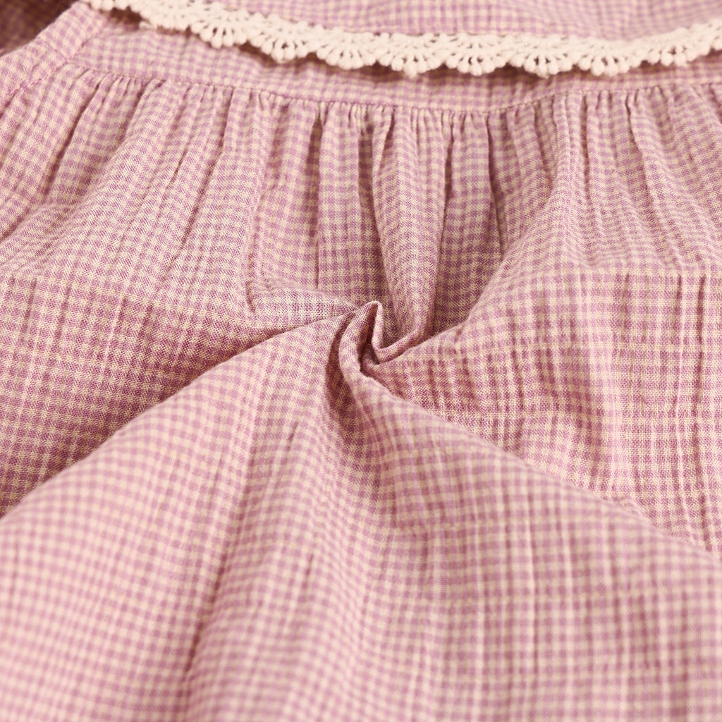 Close-up of pink checkered fabric with lace trim