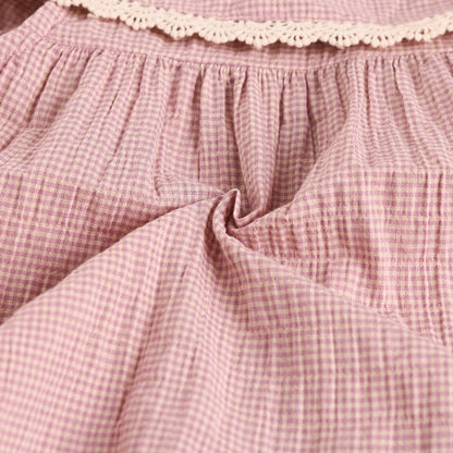 Close-up of pink checkered fabric with lace trim