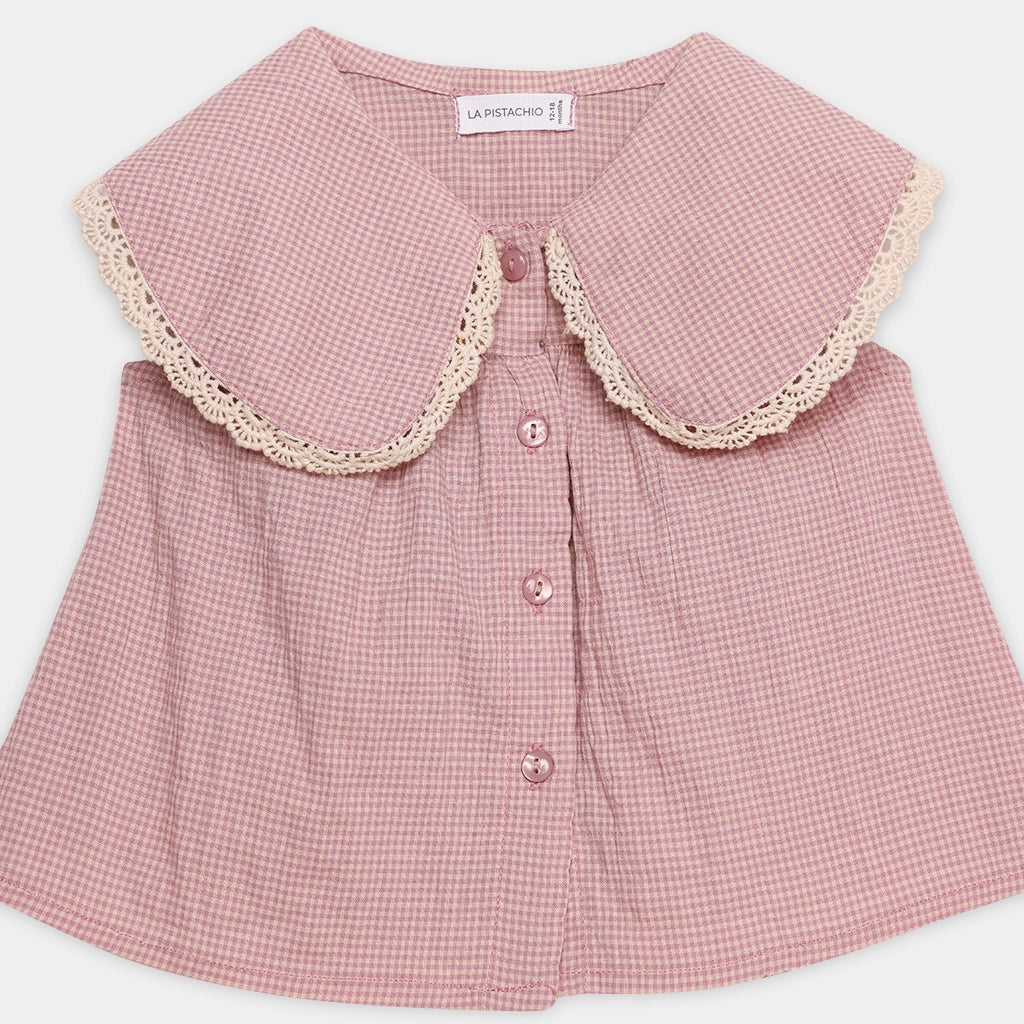 Pink checkered blouse with lace collar on a white background