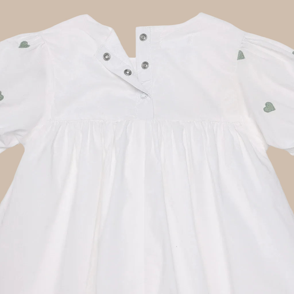 White jacket with green heart patterns on a white background