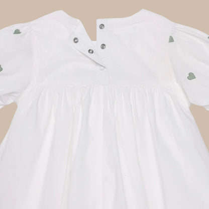 White jacket with green heart patterns on a white background