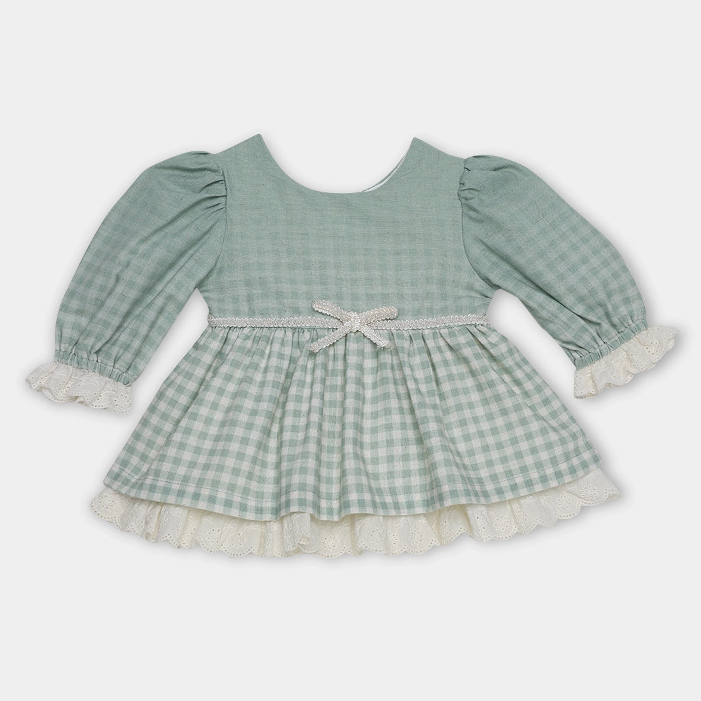 Green checkered dress with long sleeves on a light gray background