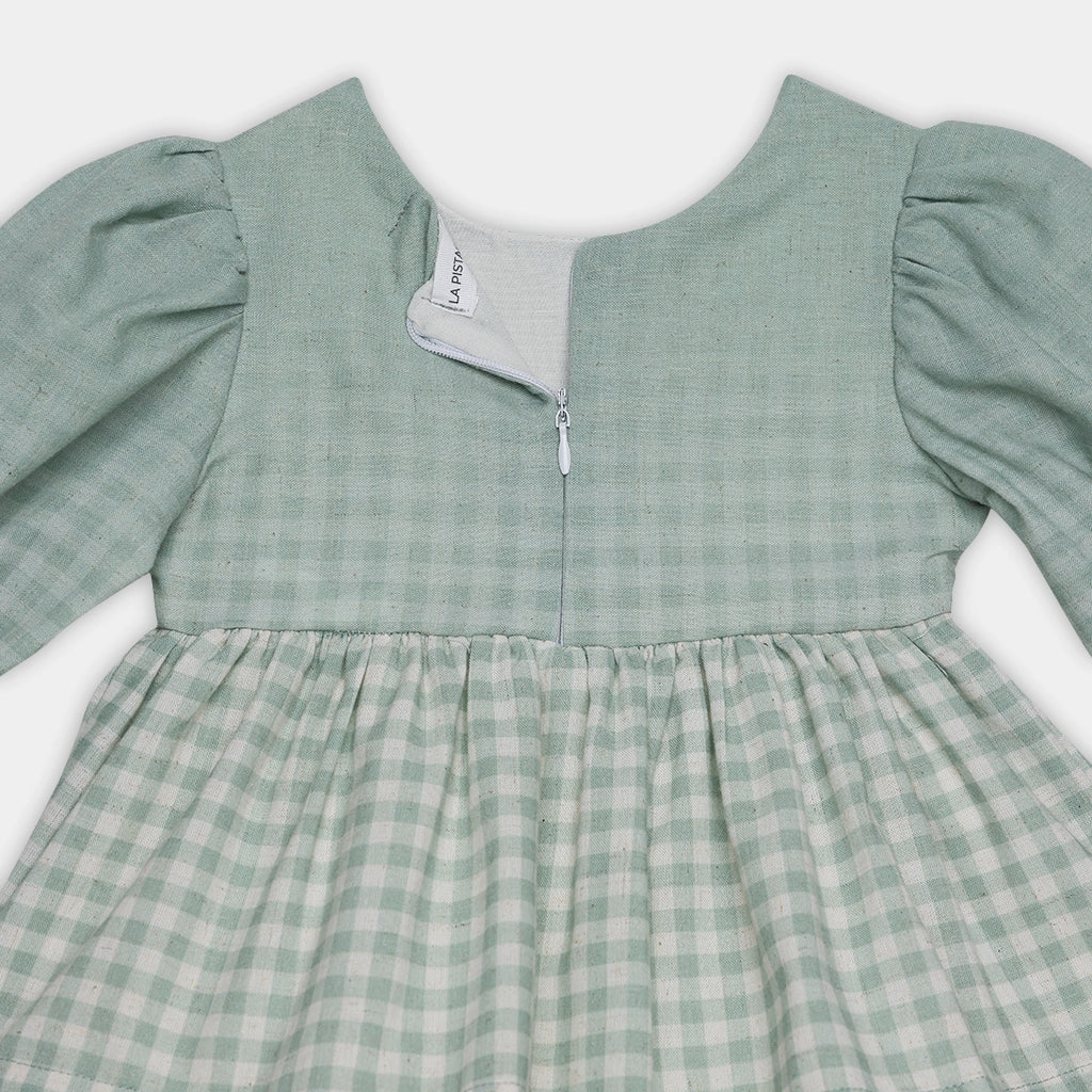 Green checkered dress with puffed sleeves on a white background