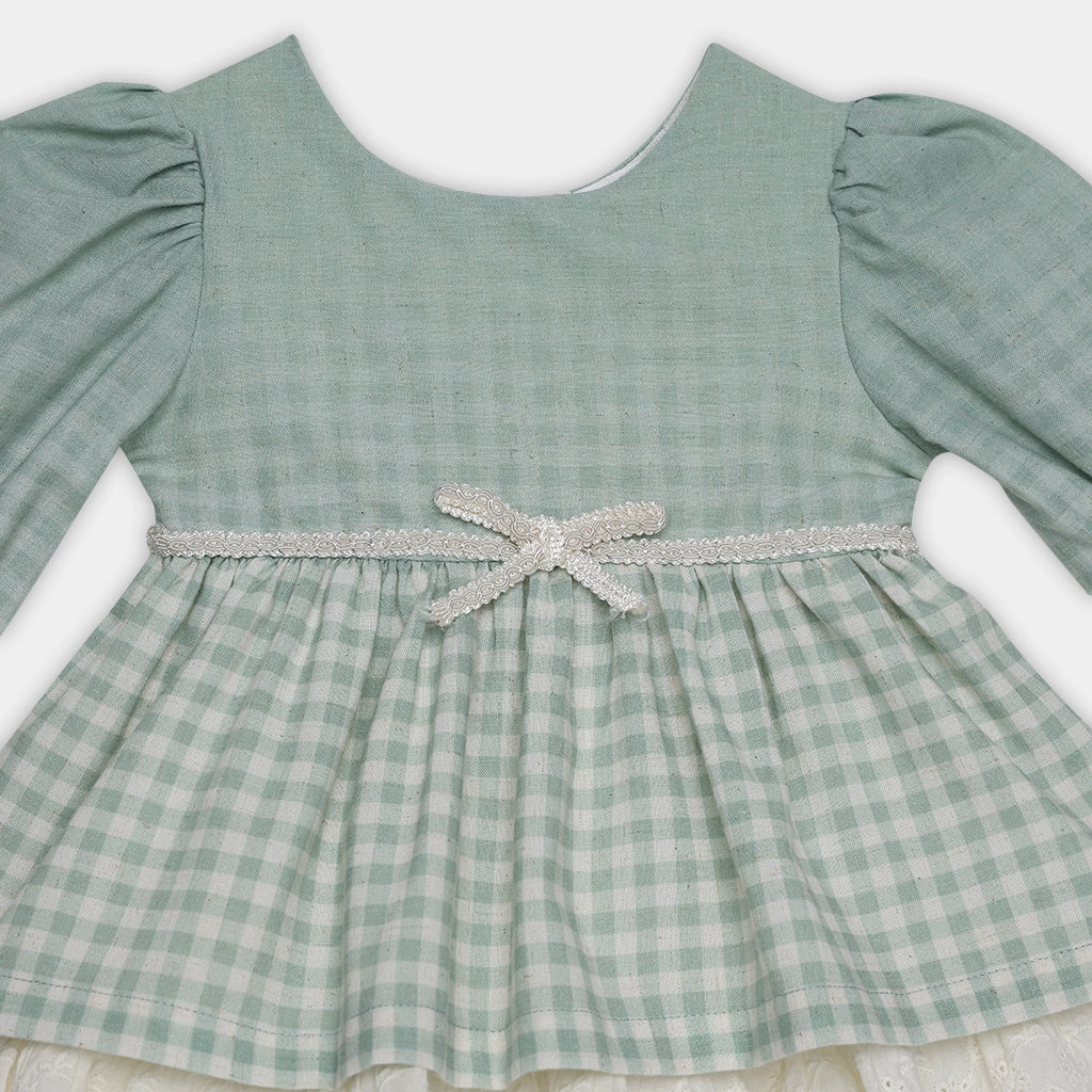 Green checkered dress with a bow on a white background