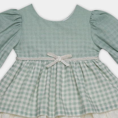 Green checkered dress with a bow on a white background