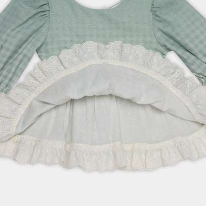 Green dress with lace trim on a white background