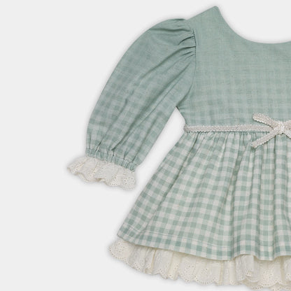 Green checkered dress with lace trim on a white background