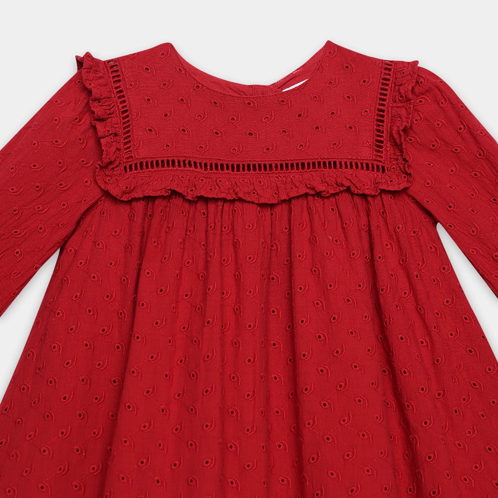 Red dress with intricate eyelet pattern on a white background
