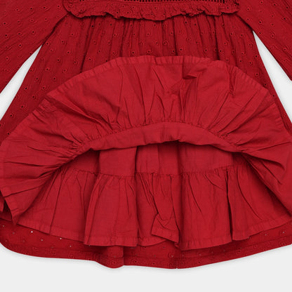Red dress with ruffled layers on a white background