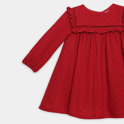Red dress with long sleeves and ruffled neckline on a light gray background