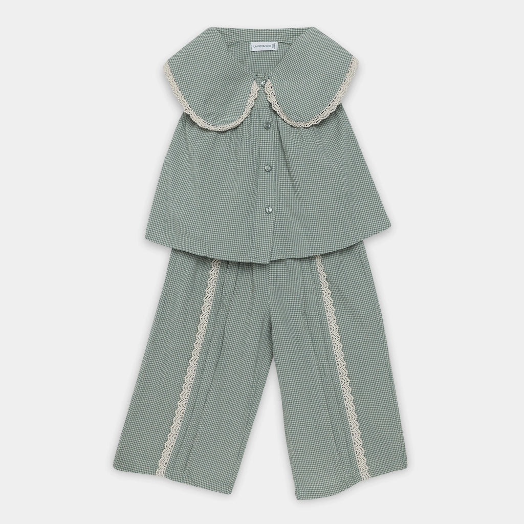 Green checkered outfit with lace trim on a white background