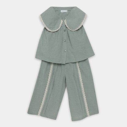 Green checkered outfit with lace trim on a white background