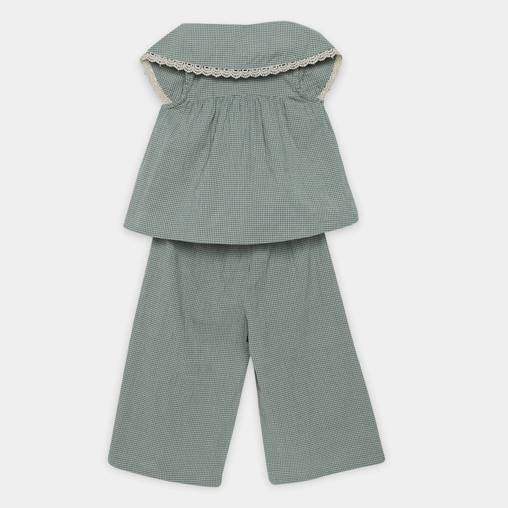 Green checkered outfit with a top and pants on a white background