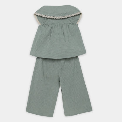 Green checkered outfit with a top and pants on a white background