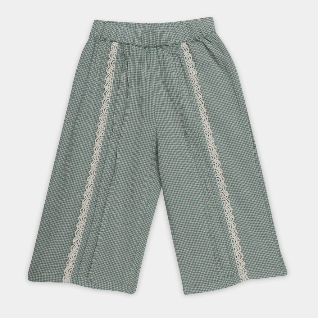 Green checkered pants with lace trim on a white background