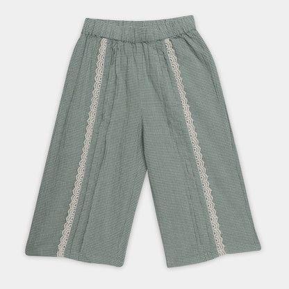 Green checkered pants with lace trim on a white background