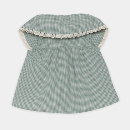 Green checkered dress with lace trim on a white background