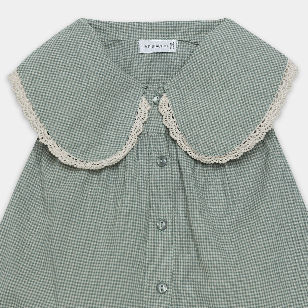 Green checkered shirt with lace collar on a white background