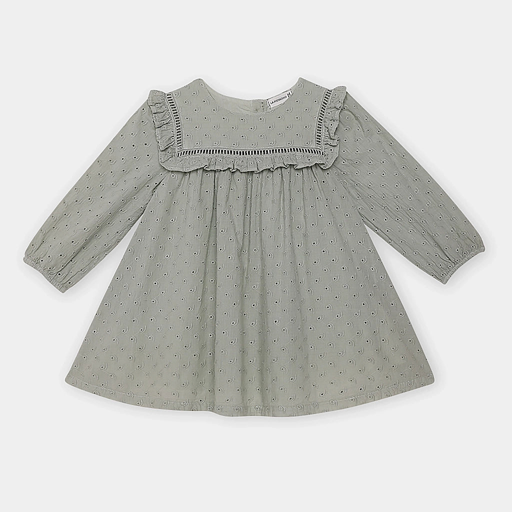 Green dress with ruffled neckline on a white background