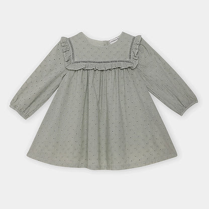 Green dress with ruffled neckline on a white background