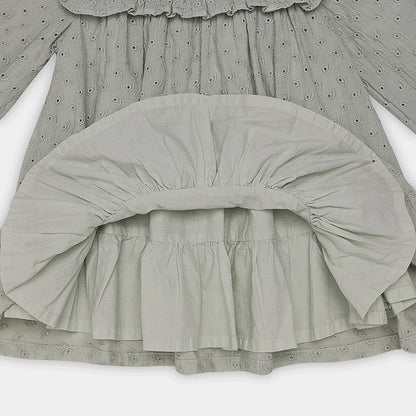 Close-up of a gray dress with ruffled details on a white background
