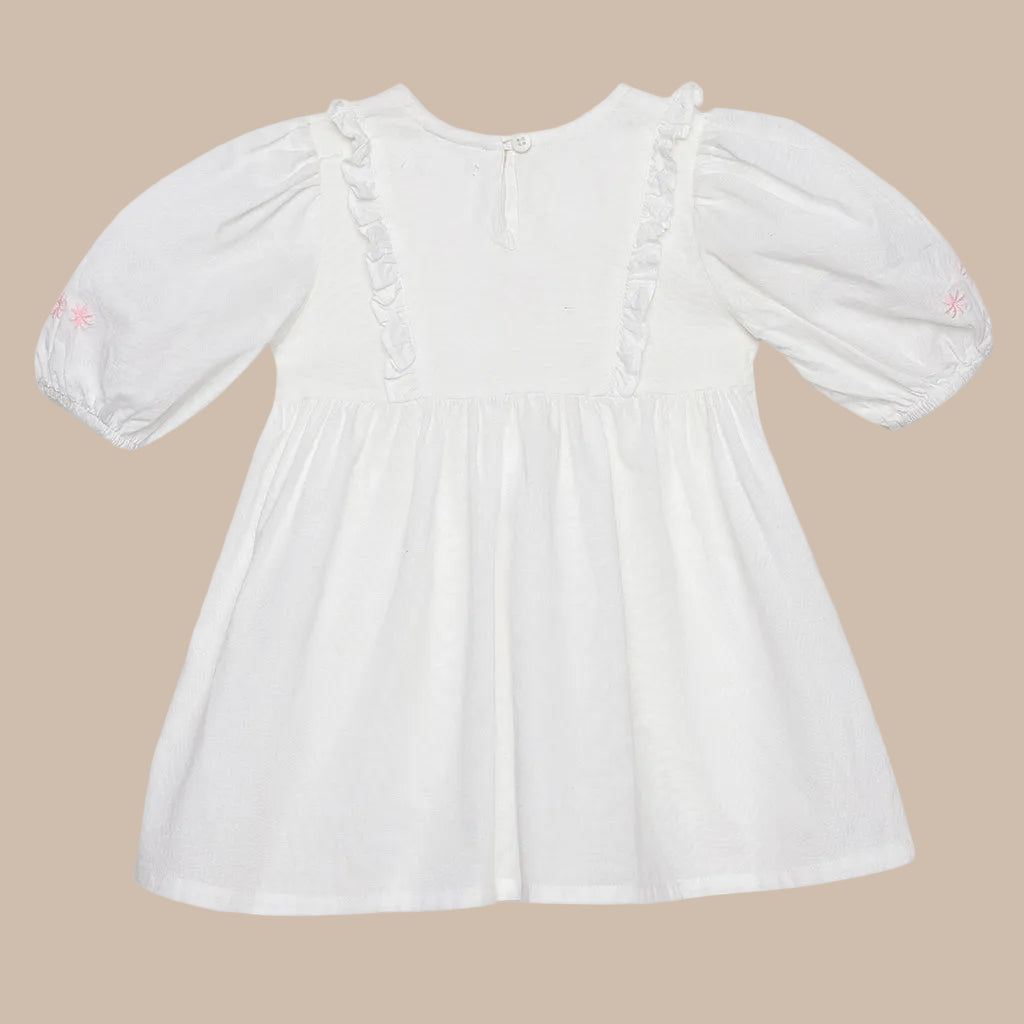 White dress with long sleeves on a light gray background