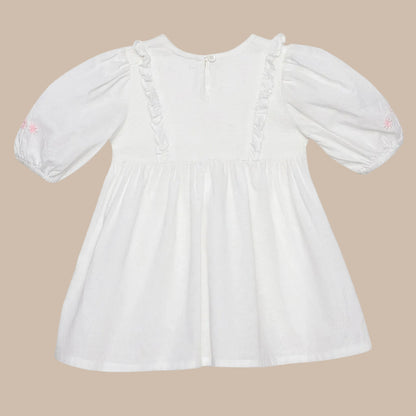 White dress with long sleeves on a light gray background