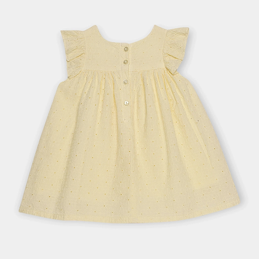 Yellow dress with a subtle pattern on a light gray background