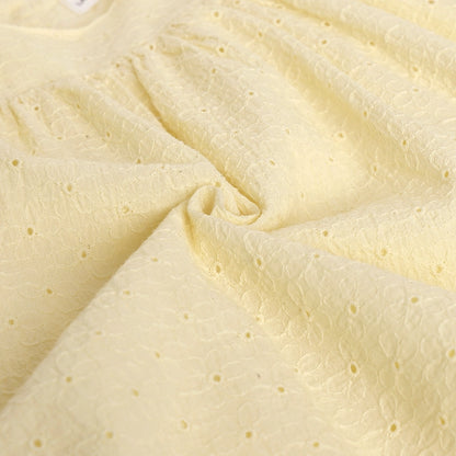 Close-up of textured beige fabric with small holes