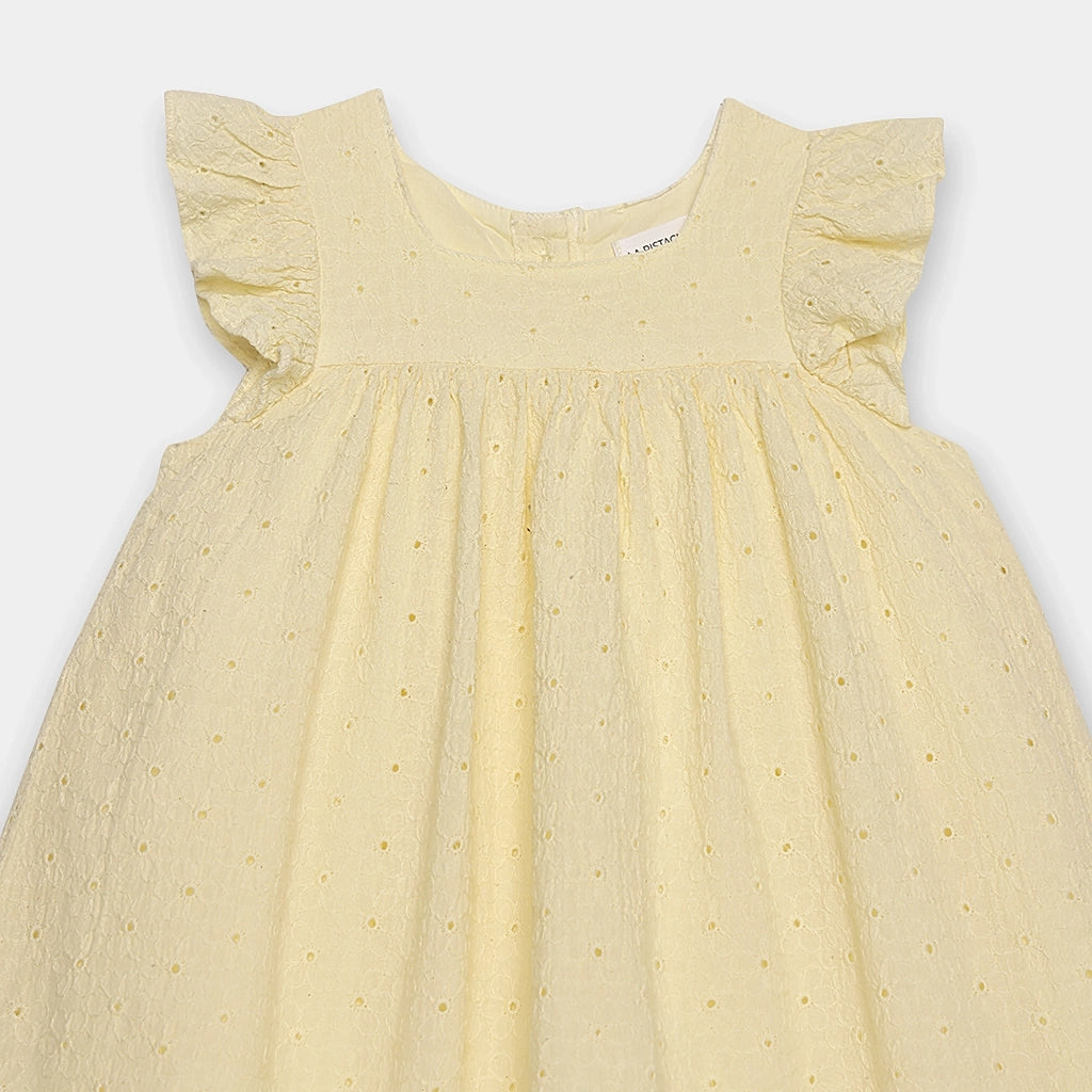Yellow dress with ruffled sleeves on a light gray background
