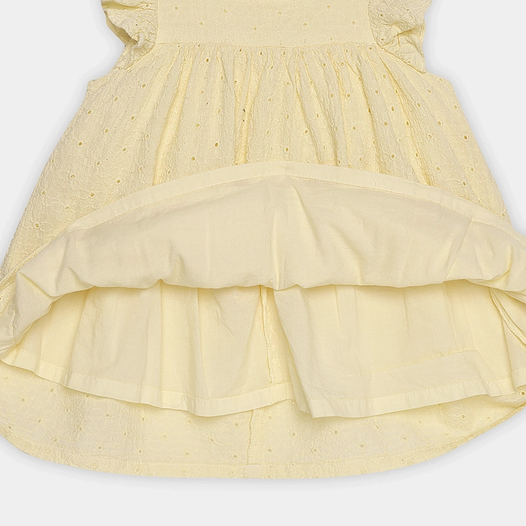 Yellow dress with ruffled layers on a white background