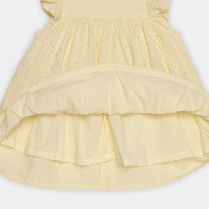 Yellow dress with ruffled layers on a white background