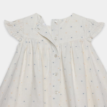White dress with small blue and orange patterns on a white background